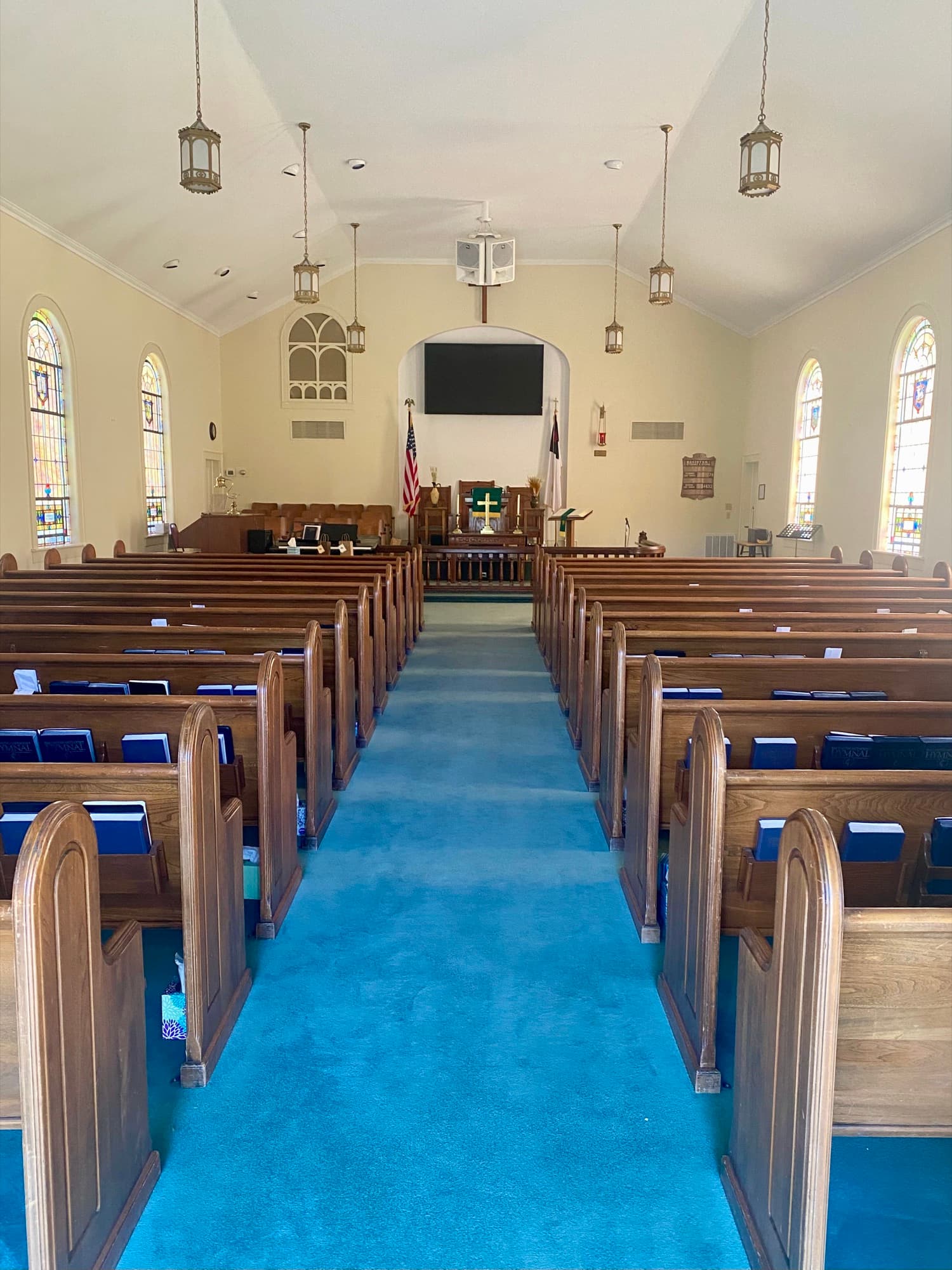 Inside the Vanderburg sanctuary with stained-glass windows